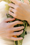 Close-up of 14K solid gold emerald ring with channel-set diamonds